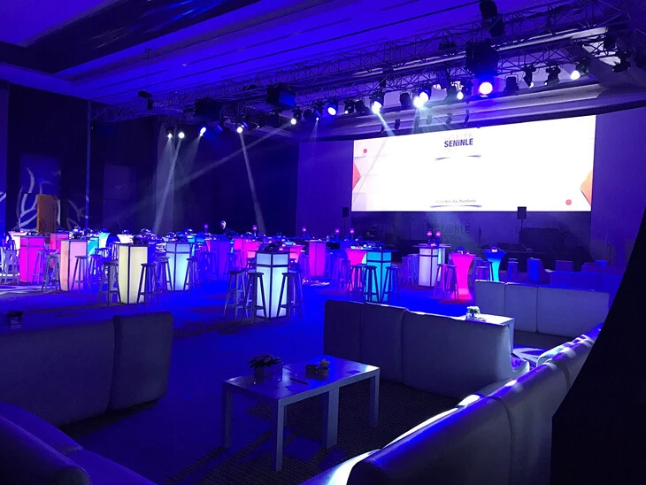Modern indoor concept party styling with illuminated cocktail bars, lounge furniture and dynamic stage lighting for a corporate night event in Antalya, Bodrum and Cappadocia