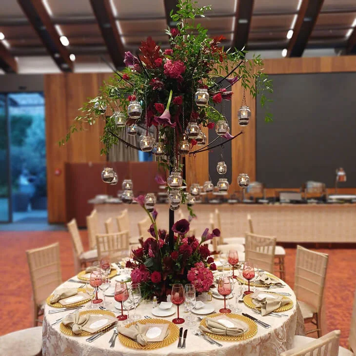 Floral centerpiece table decoration with suspended candle details, luxury tableware and artistic event styling in Antalya, Bodrum and Cappadocia