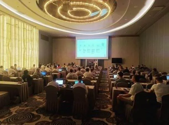 Corporate event in Turkey with attendees seated at classroom-style tables facing a presentation screen